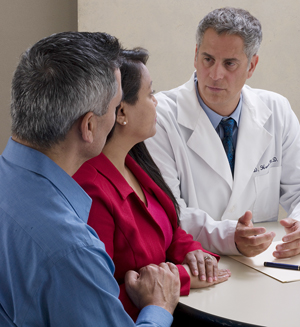 Man and woman talking to healthcare provider.