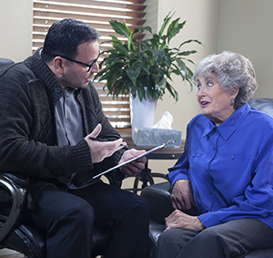 Speech therapist working with woman.